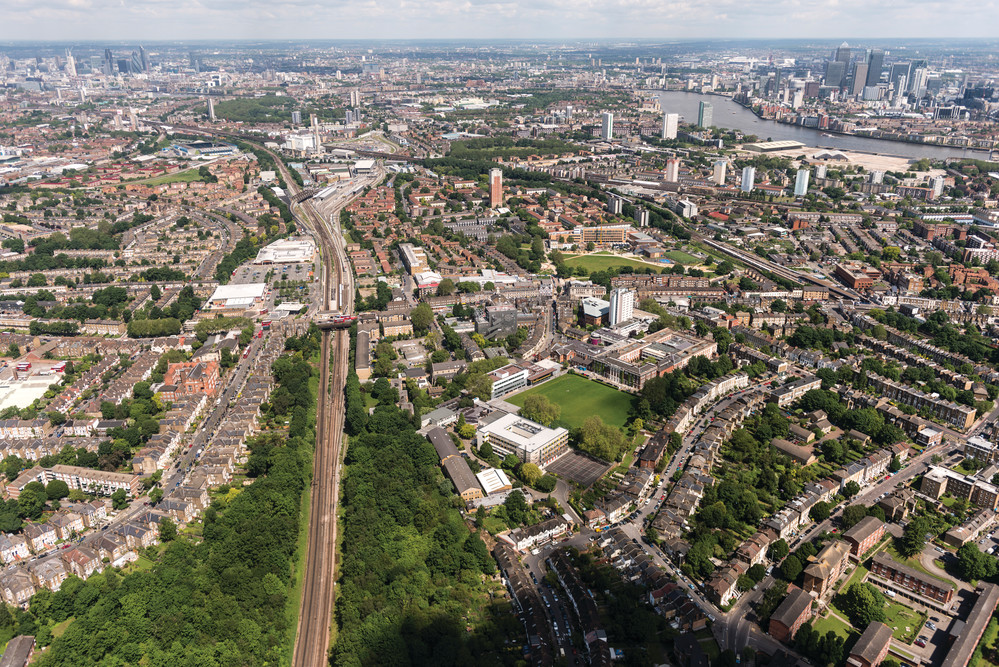 Aerial photo of Goldsmiths' campus (foreground) in Lewisham with the River Thames, City of London and Canary Wharf in the background.