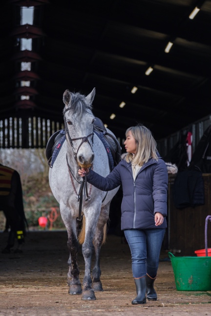 A student at the RAU equestrian centre walking with a horse