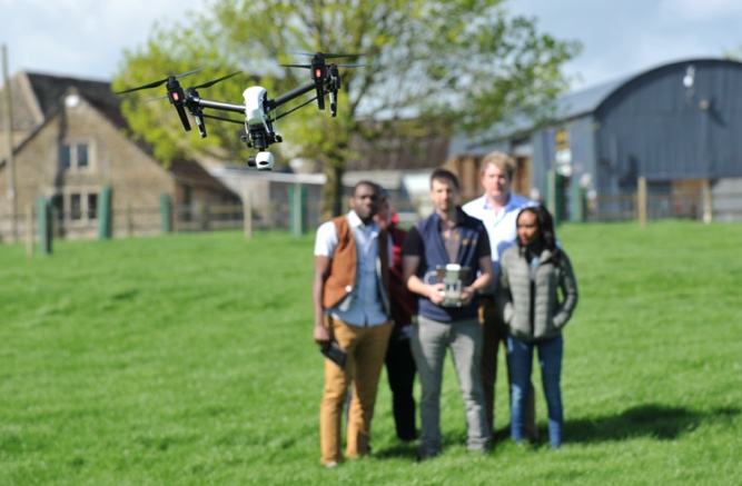 A group of students at the JORIC flying a drone as part of a workshop showing argri-tech
