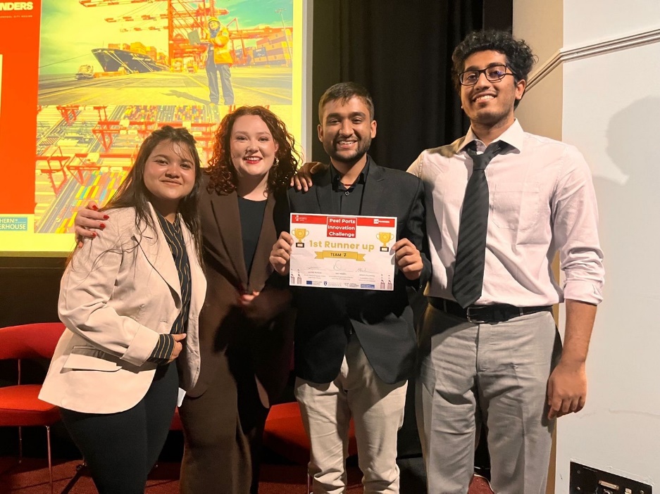 Figure 4 shows four students participating in the 2022 Peels Ports Innovation Challenge as part of the LCR Founders Project. The third student from the left is holding up a certificate.