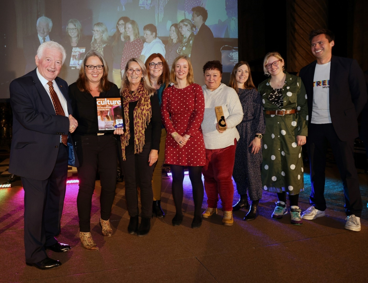 A colour photograph of the Street Museum team collecting their award for Best Arts and Education Partnership at the North East Culture Awards 2022.