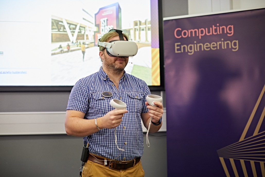 Photography of a person operating virtual reality equipment infront of a projection screen