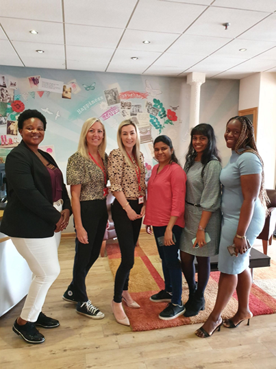 Four students smile with two ladies from UK Greetings