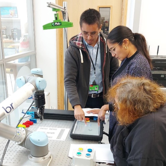 A group of people looking at a tablet
