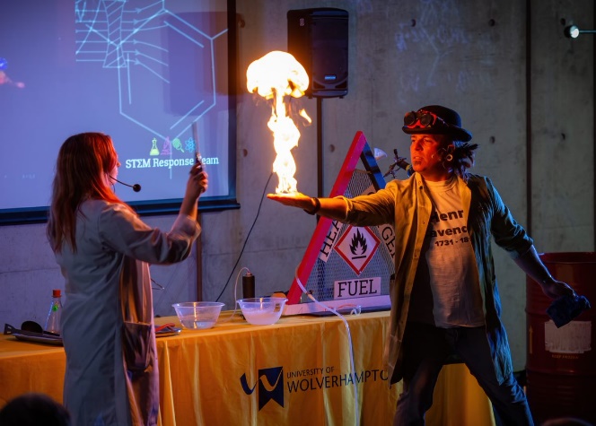 Photograph of 2 members of the STEM Response Team carrying out an experiment