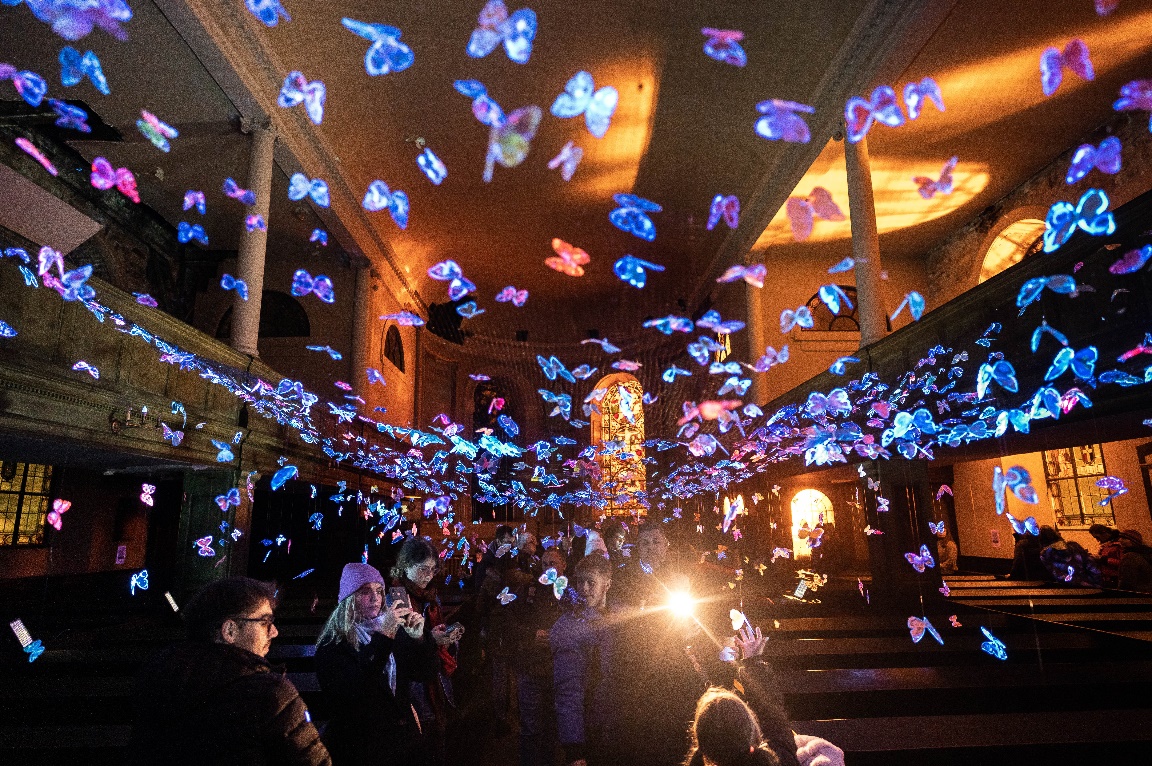 A church with hand-made butterflies suspended above the aisle.