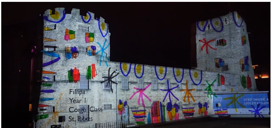 Screenshot of Youtube video featuring the Oxford Castle at 950 Years - Son et Lumière event, with an image still of the castle and child's artwork projected onto the face of the castle.