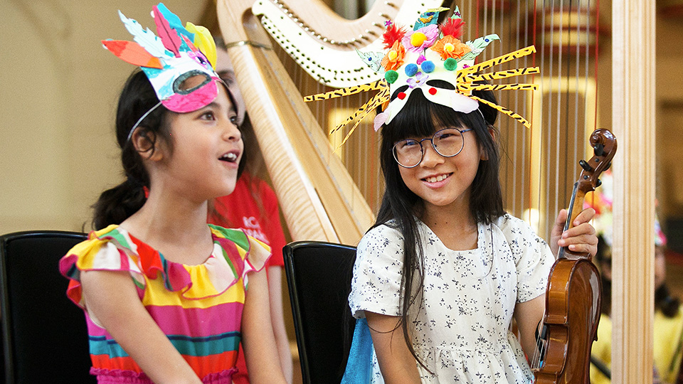 Two children with handmade masks on, engaging in an RCM Sparks event