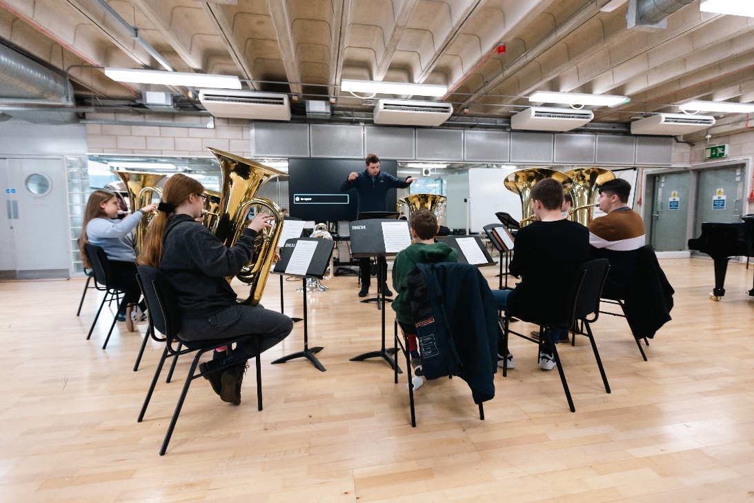RNCM young brass musicians in an ensemble rehearsal.