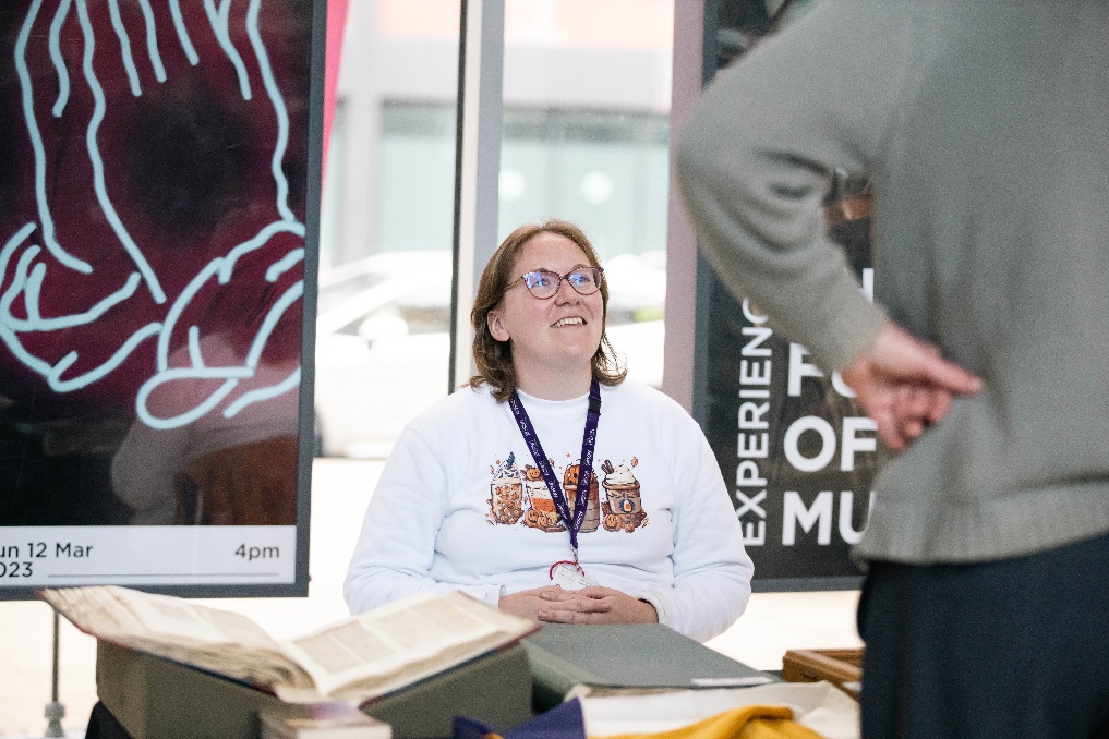 RNCM archivist showing RNCM visitors items from the archives.